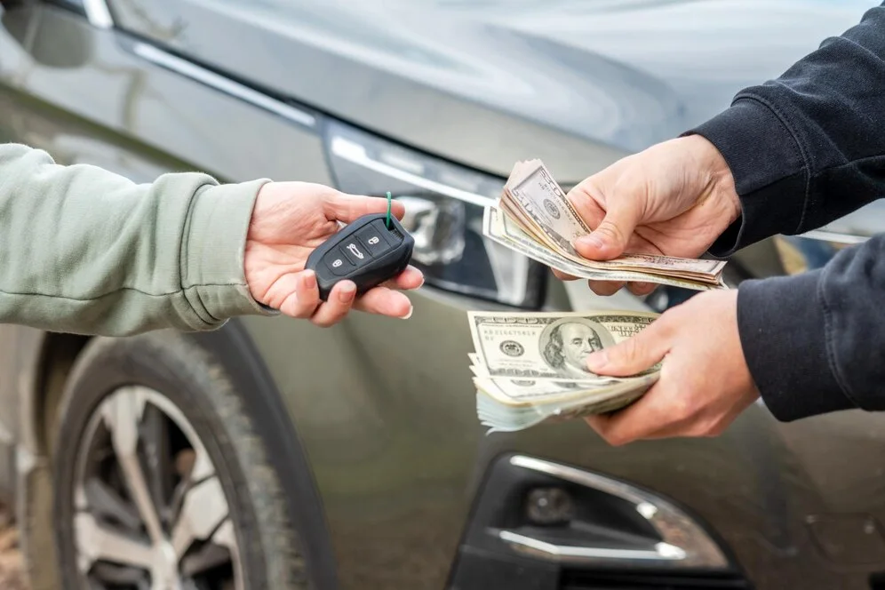 Car dealership agent handing over keys and contract to customer, lemonmyvehicle