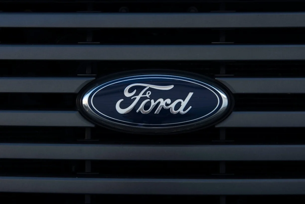 Close-up of the Ford oval logo on the front grille of a vehicle, lemonmyvehicle