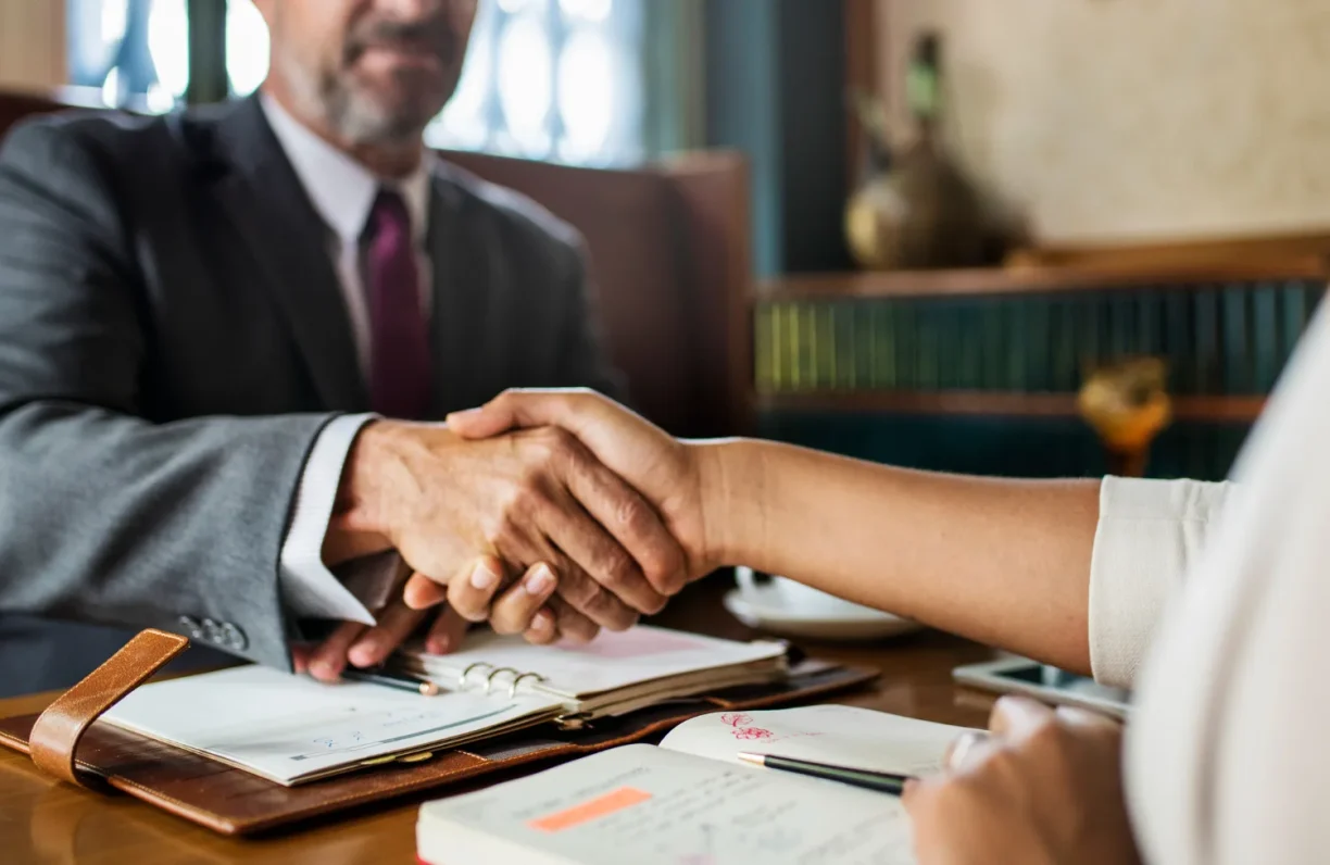 Handshake between lawyer and client in office setting, lemonmyvehicle