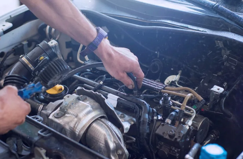 Mechanic working on a car engine during maintenance or repair, lemonmyvehicle