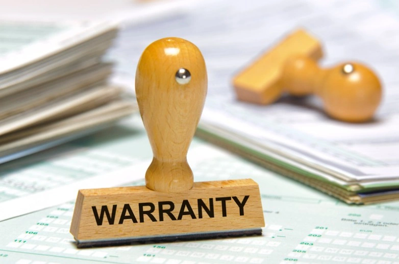 Wooden warranty stamp on a stack of documents and spreadsheets, lemonmyvehicle