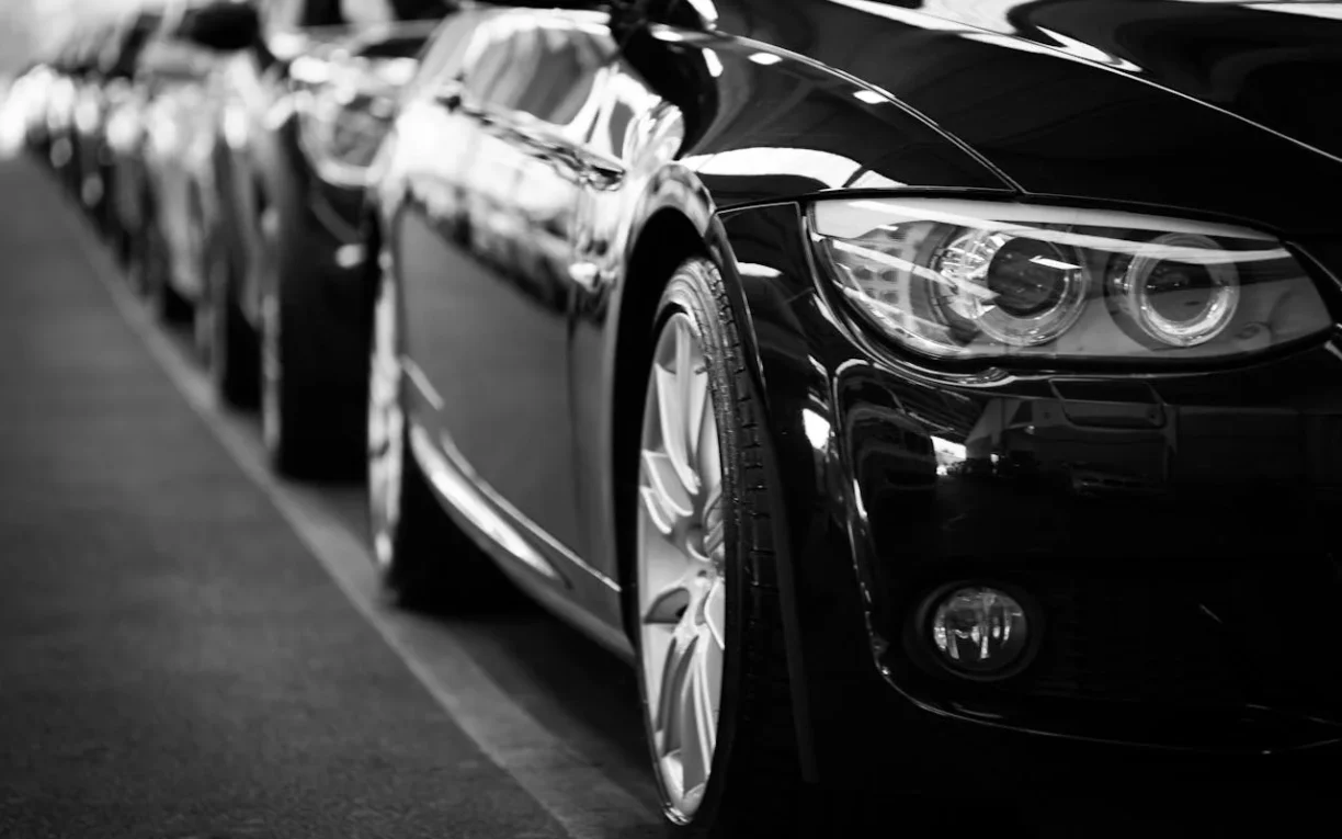 A row of new black cars, illustrating recently purchased vehicles that could potentially be subject to Lemon Law claims due to defects.