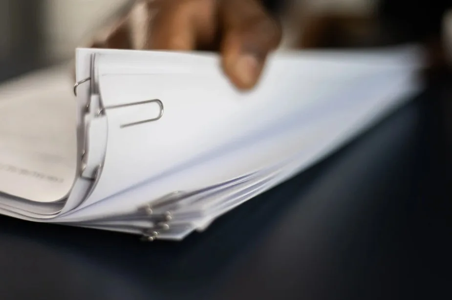 Close-up of legal documents prepared for a Lemon Law claim regarding a faulty vehicle