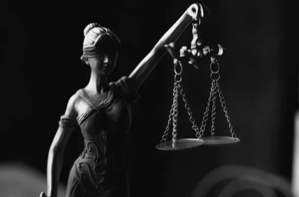 Lady Justice statue holding the scales of justice, symbolizing fairness and law
