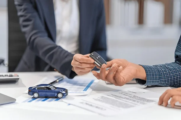 Car buyer receiving keys after signing an auto purchase contract with Lemon Law assistance for defective vehicles
