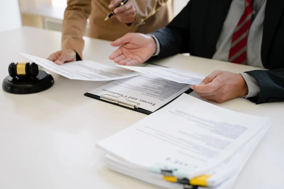 Lawyer reviewing terms and conditions for a defective vehicle claim under Lemon Law