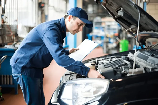 Mechanic inspecting a car engine during evaluation, highlighting vehicle defects and warranty repair concerns under lemon law.