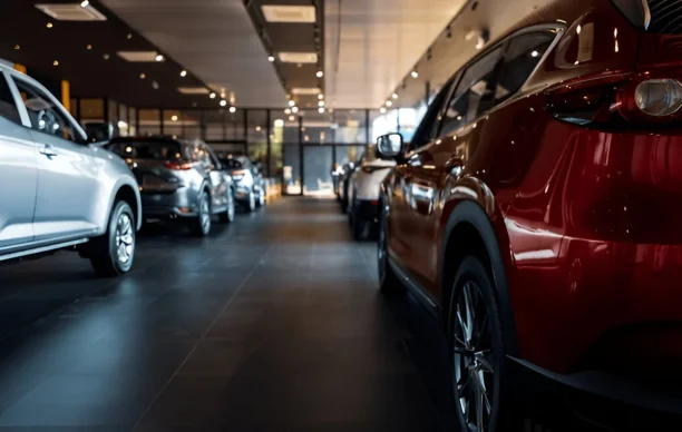 Cars lined up in dealership showroom highlighting potential lemon law cases