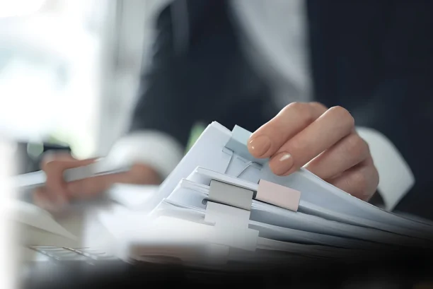 Lawyer reviewing legal documents and case files for lemon law claim
