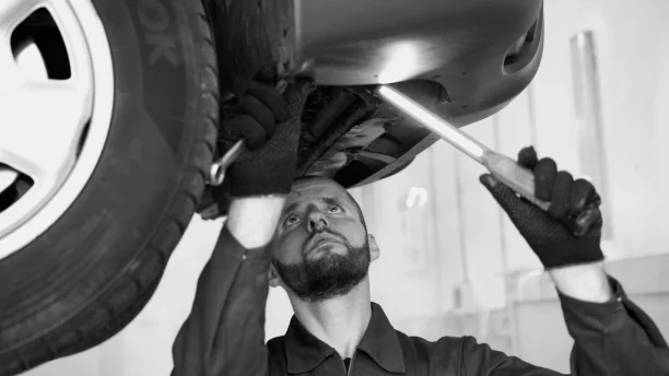 Smiling woman holding car keys at dealership after purchase under lemon law rights