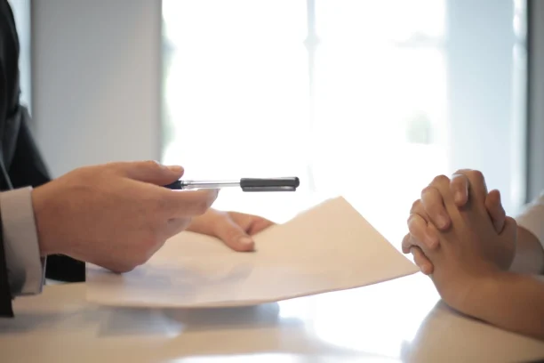 Person signing lemon law documents for defective vehicle claim
