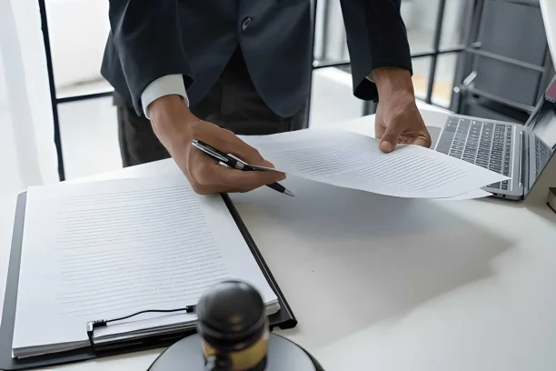Attorney reviewing Lemon Law paperwork for a vehicle defect claim