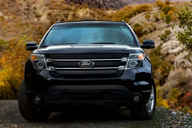 Black Ford SUV parked outdoors with mountain scenery in the background.