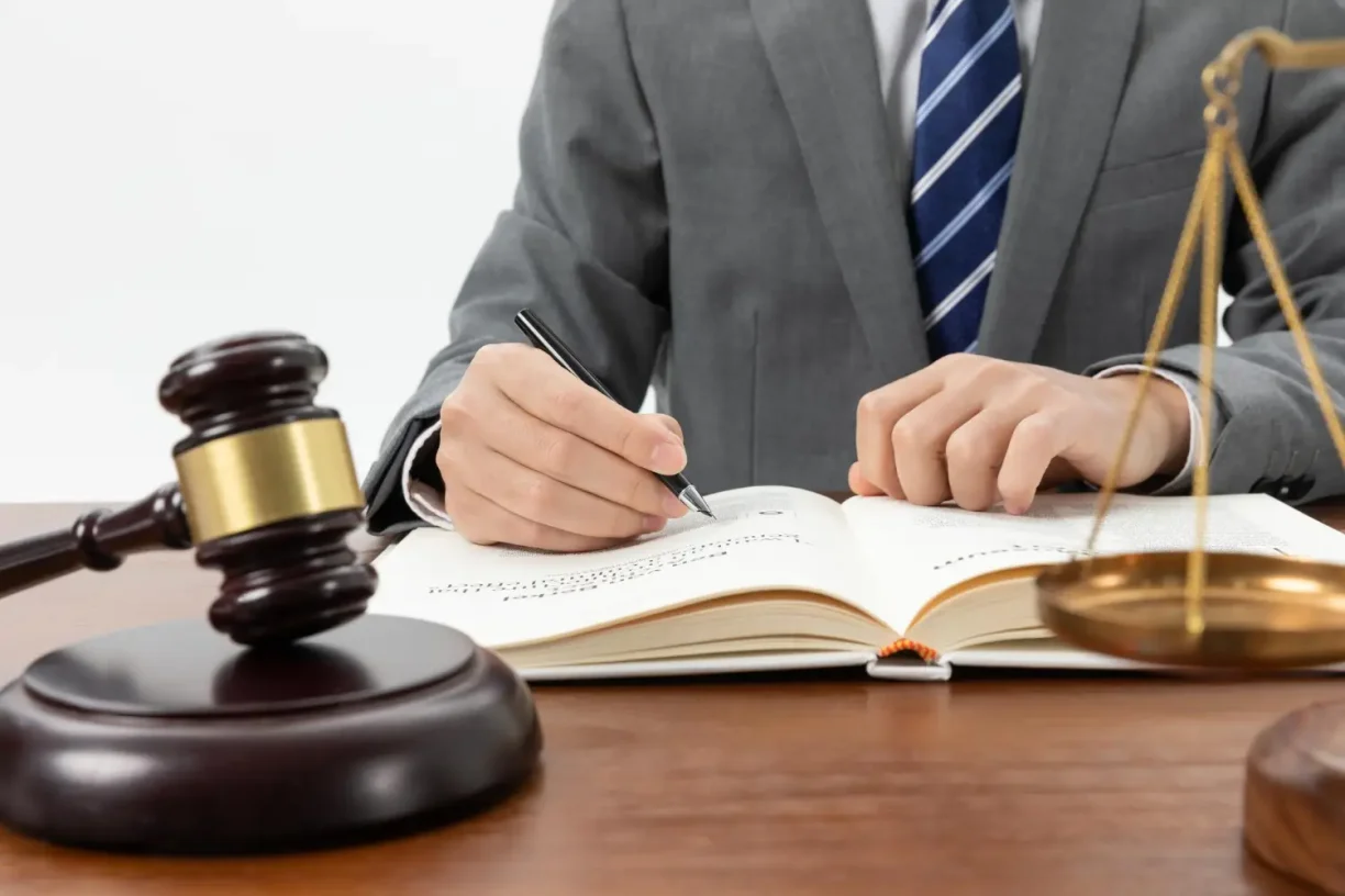 Attorney reviewing legal documents related to vehicle warranty and lemon law cases