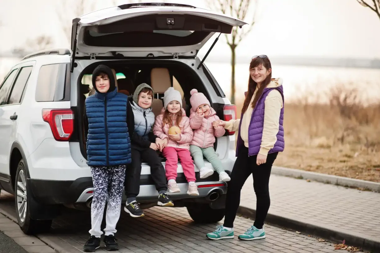 Family standing by an SUV showing a vehicle commonly involved in lemon law claims and warranty disputes