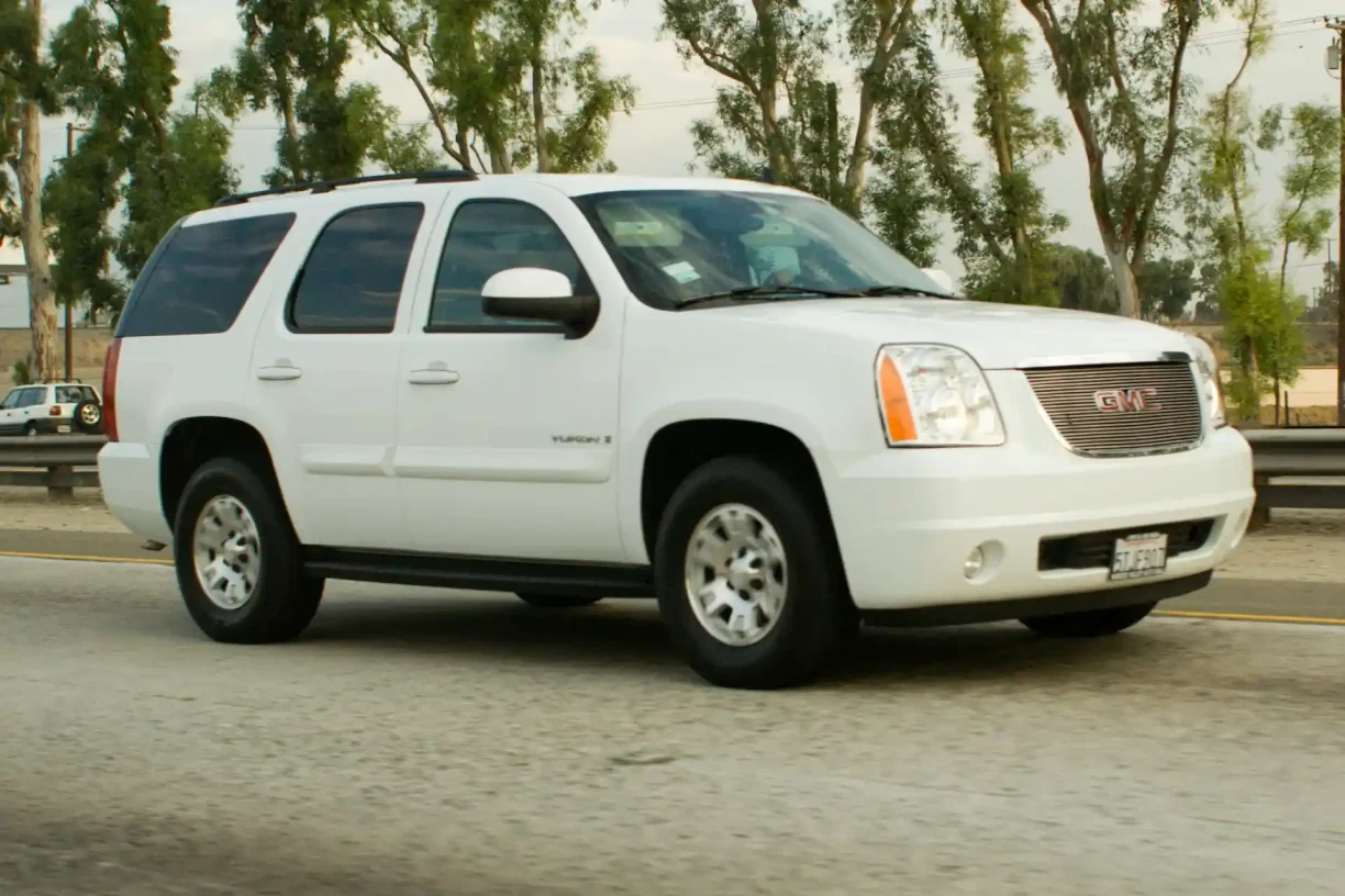 GMC Yukon SUV driving on highway, vehicle potentially eligible for Lemon Law claim