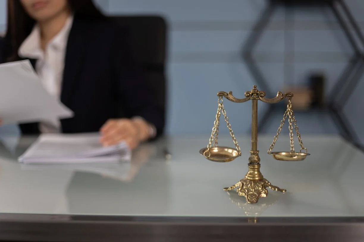 Lemon Law attorney reviewing vehicle defect case with legal scales symbolizing consumer rights