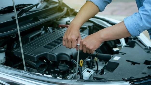 Vehicle owner checking engine oil level during repeated mechanical issues