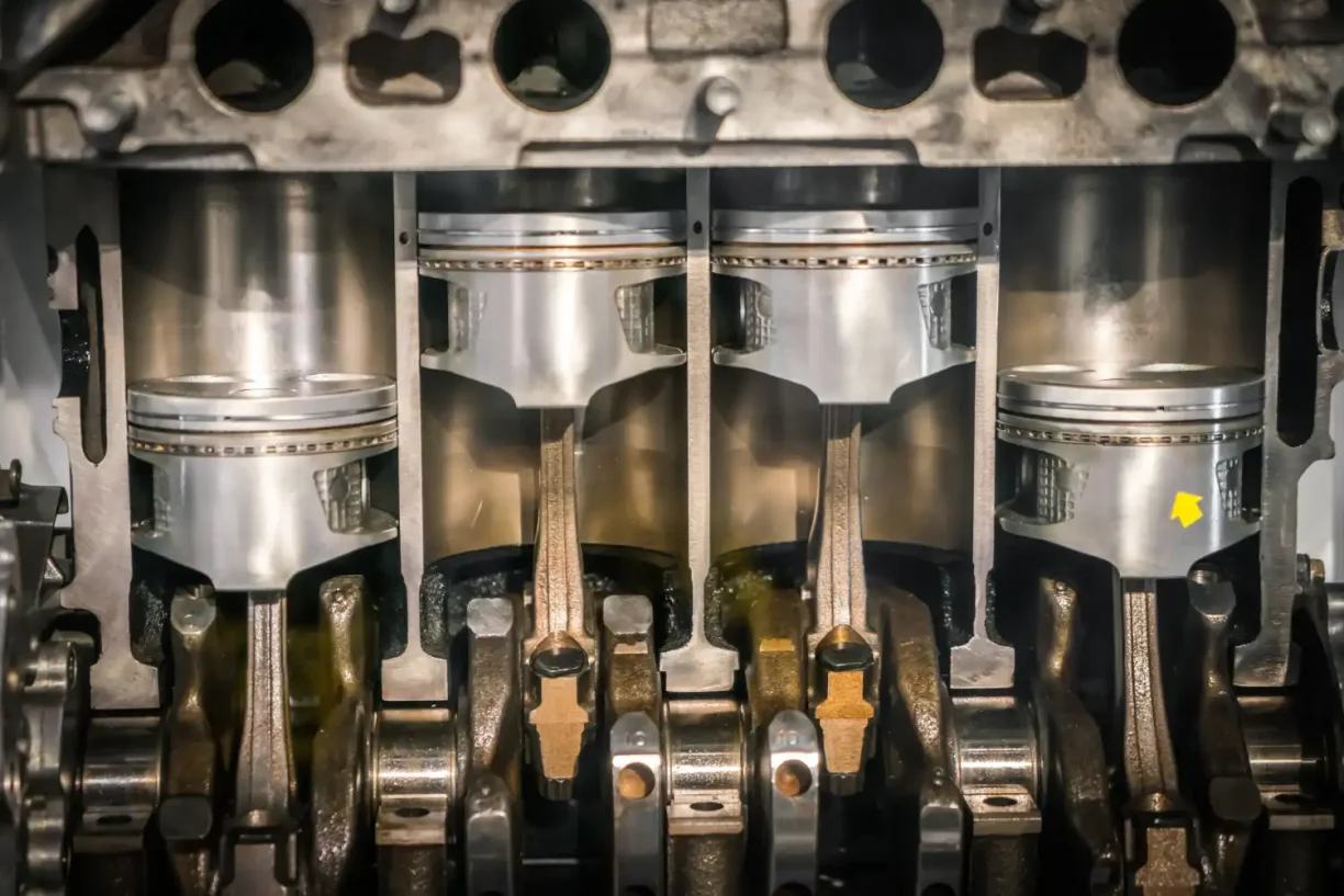 Close-up view of engine pistons and internal components, illustrating serious mechanical defects that can lead to lemon law claims.