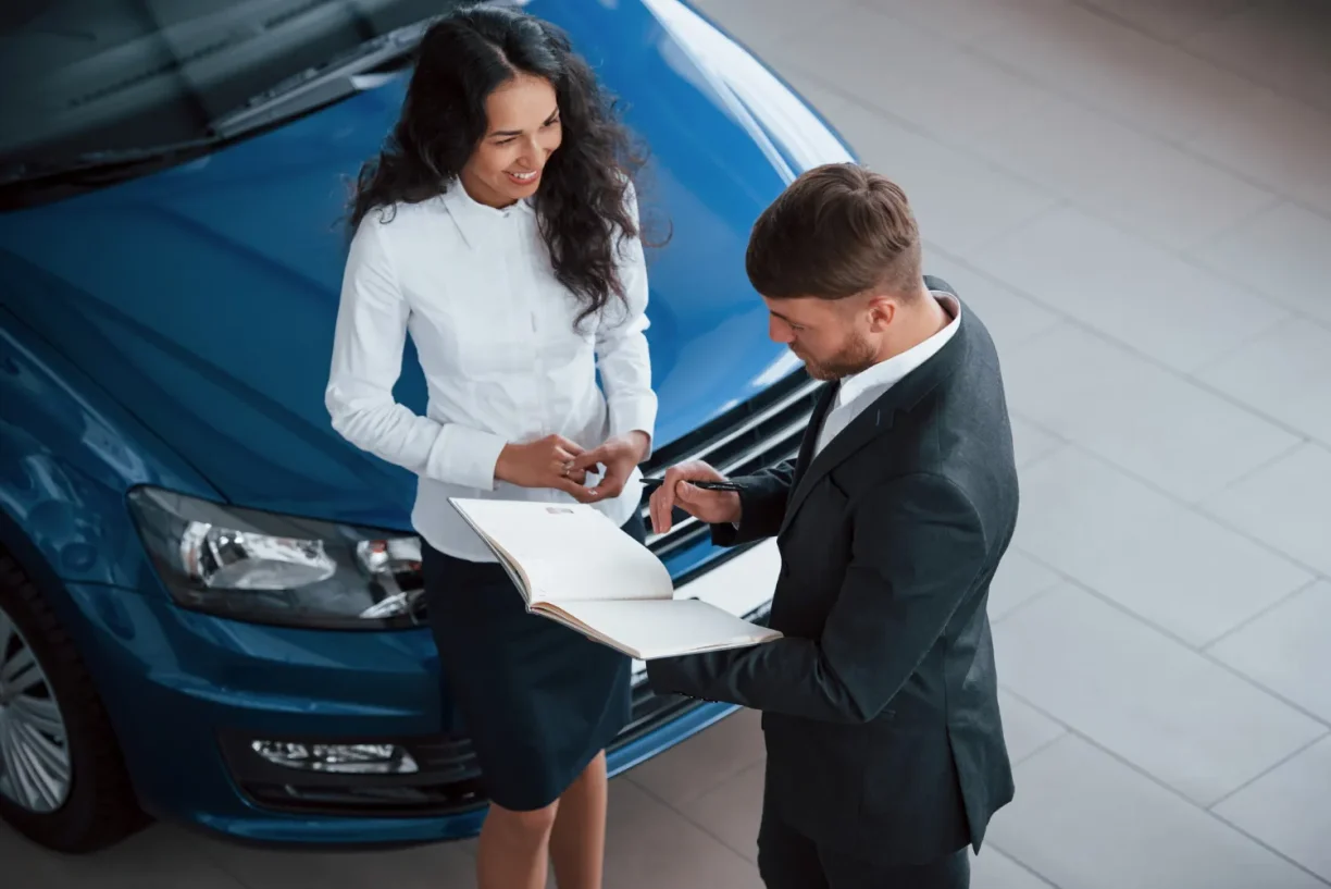 2023 Hyundai Santa Fe owner reviewing lemon law claim documents with attorney at dealership